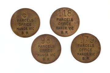 4 circular brass parcel tokens. All are marked with 'PARCELS OFFICE