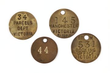 4 circular brass parcel tokens