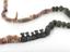 Necklace consisting of coloured stone beads and small black