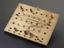 A wiring test comprised of a wooden board with 36 holes for