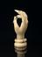 Carved ivory hand on circular stand, fingers curved