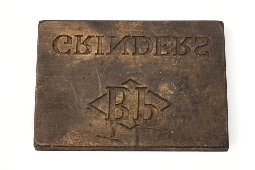 A printing block with a surface image with the text "BP