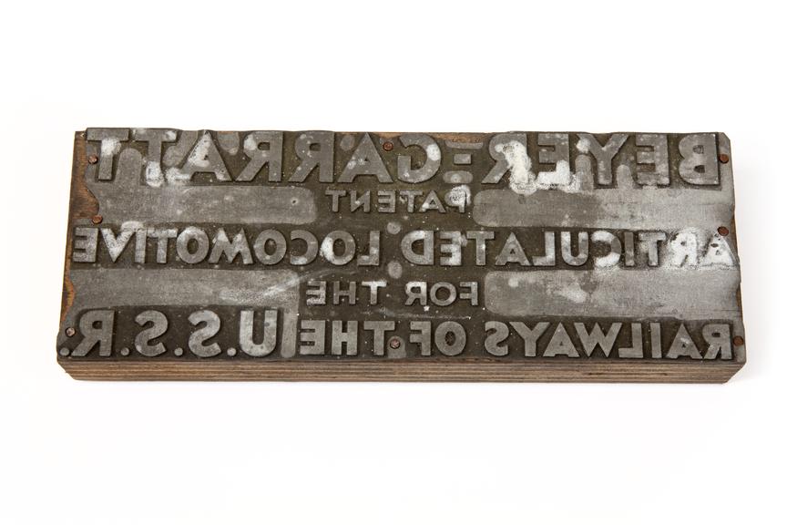A printing block with the surface image of text: "Beyer-Garratt