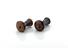 Pair of carved horn earplugs, black with polychrome ring design