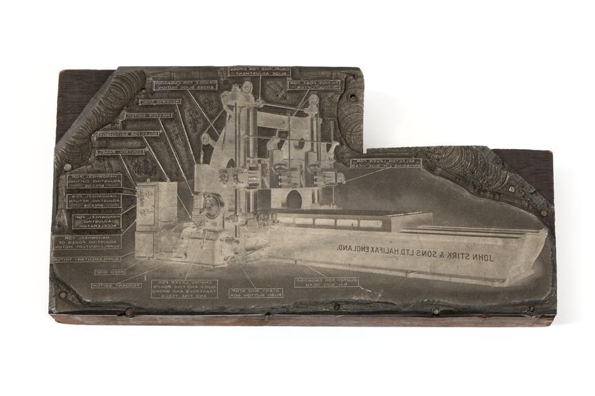 A printing block with a surface image of workshop machinery