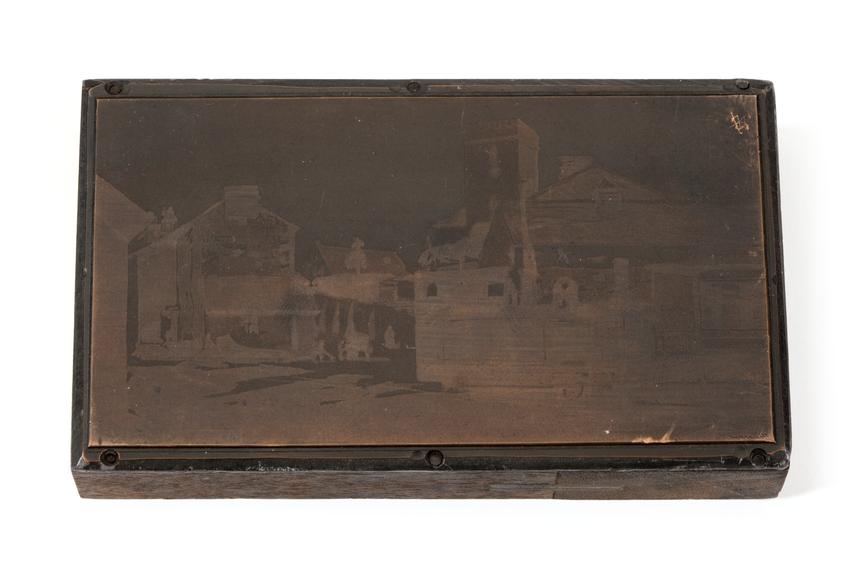 A printing block with a surface image of a locomotive at an