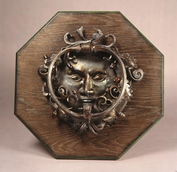 Door knocker of face and acorns made by Paul Allen