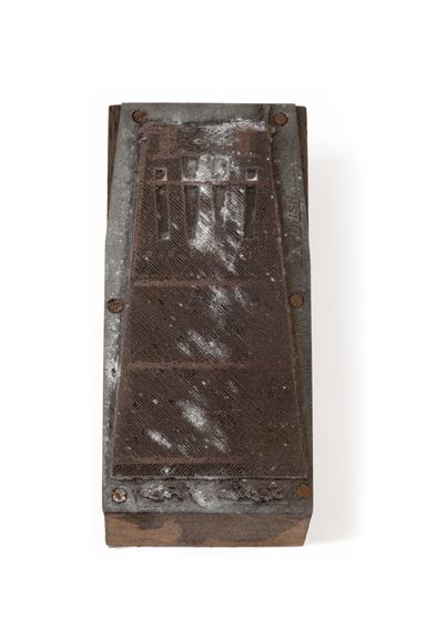 A printing block.
Photographed on a white background.