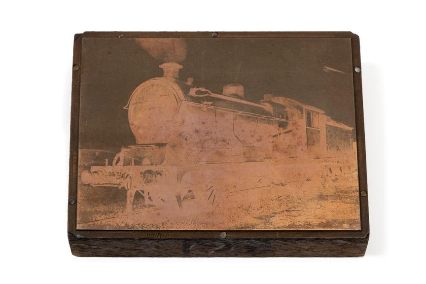 A printing block with a surface image depicting a locomotive