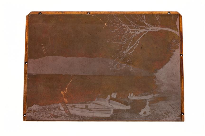 A printing block surface plate with an image of a lake and