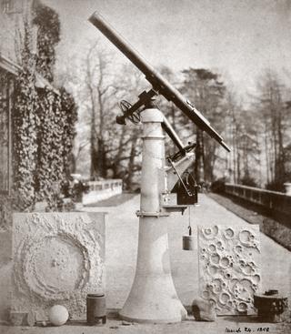 Calotype print by Nasmyth of lunar crater models and a refracting telescope outside his home in England, 1858