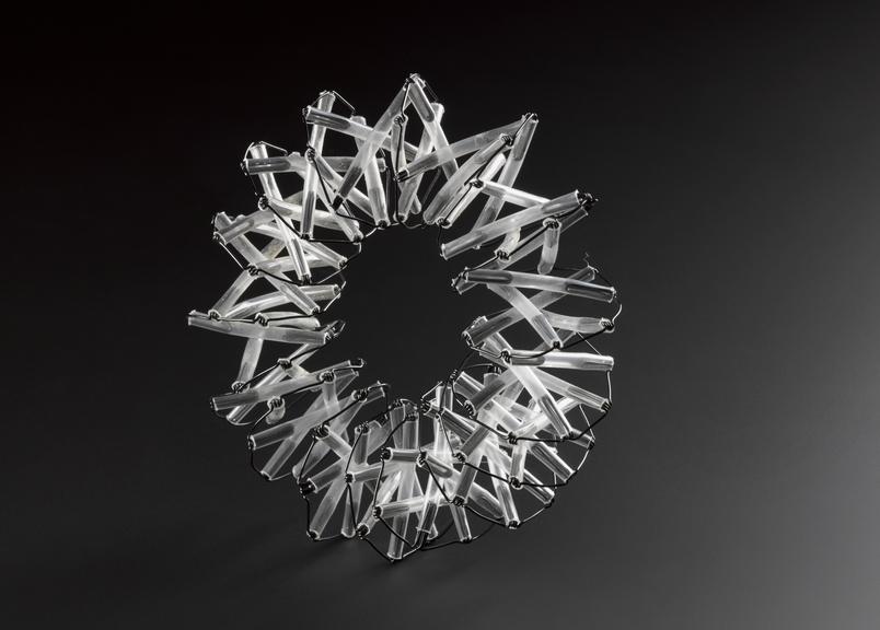 Model, of a double helix, forming a torus shape