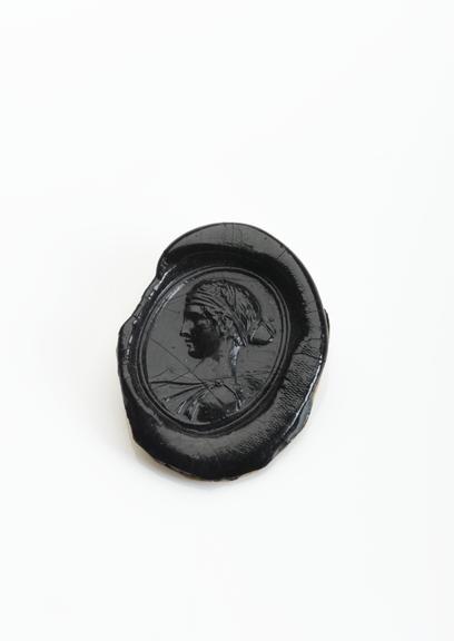 Black shellac seal and stamp showing female head