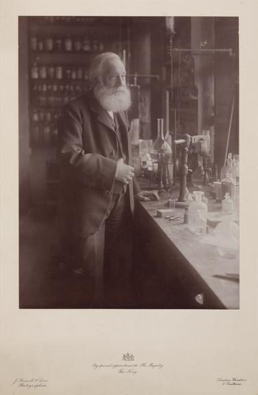 W H Perkin, standing, in the laboratory at Sudbury