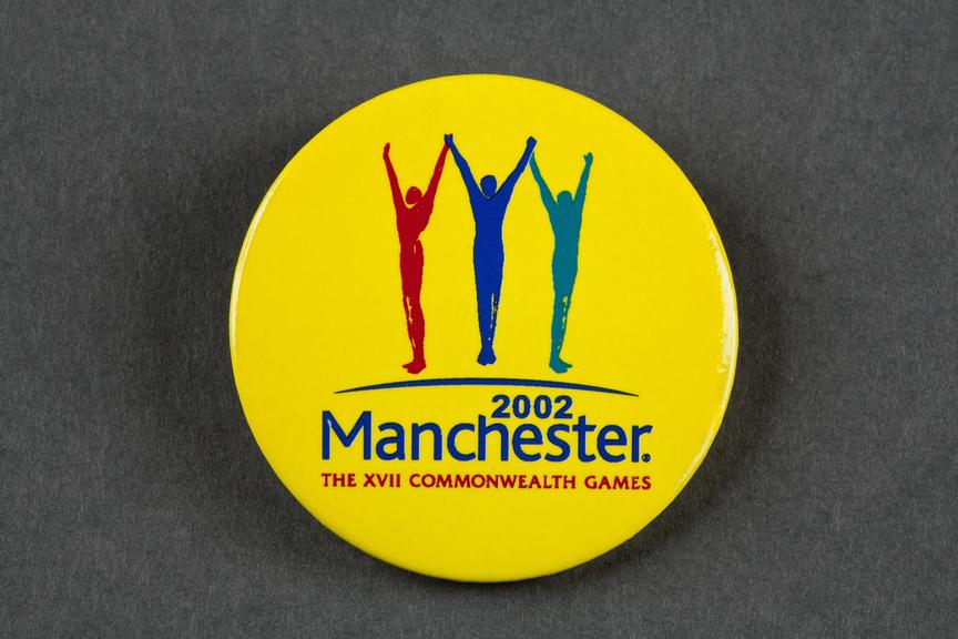 A circular yellow badge from the 2002 Manchester Commonwealth