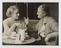 A photograph of of Ellen Wilkinson seated with Margaret