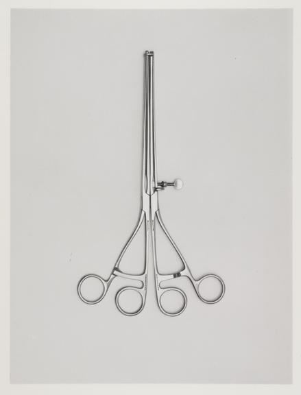 A black and white print of a surgical instrument.