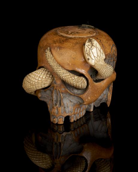 Tobacco jar carved in the form of human skull and snake