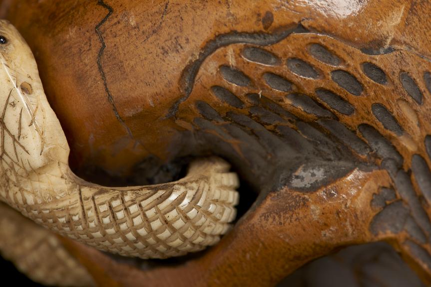 Tobacco jar carved in the form of human skull and snake