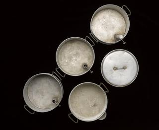 Set of 4 stacking steaming pans each with a pair of handles