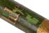 Long green painted wooden staff decorated with gold bands and