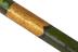 Long green painted wooden staff decorated with gold bands and