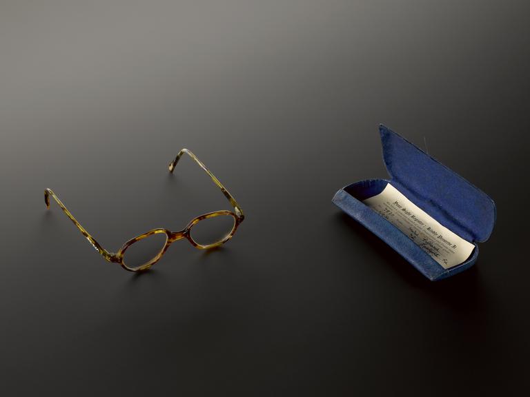 Pair of plastic National Health Service spectacles in blue case