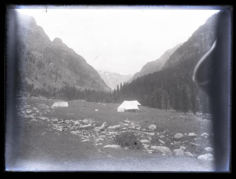 A mountainous scene with a tent