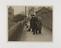 Photograph of men inspecting the ground for the murder case of