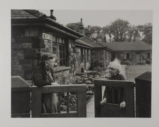 Photograph of pensioners at the gateway of the Lomeshaye Place Estate
