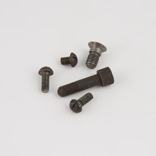 Five machine screws: three raised head, a countersunk and a cheese-head, for double grindstone model