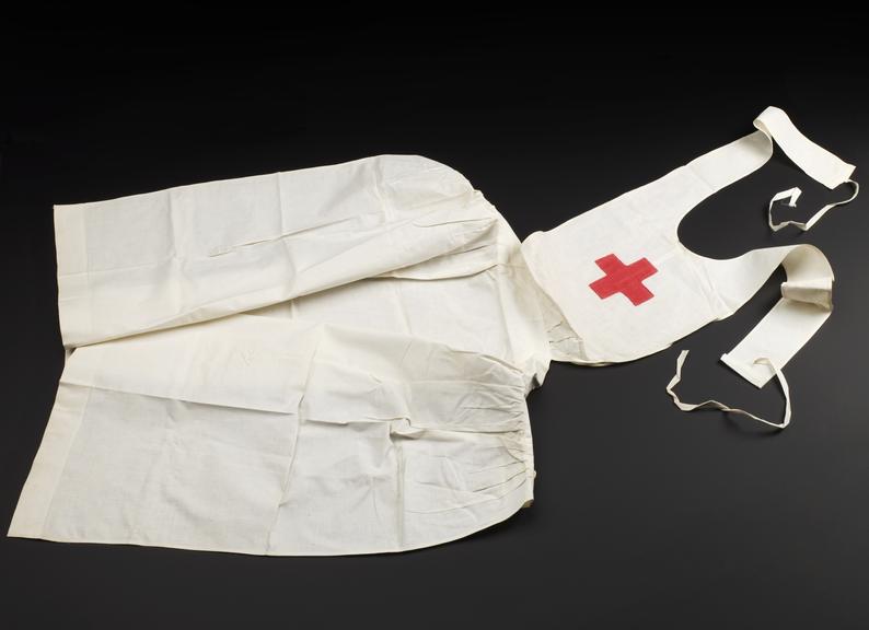 White cotton apron with a red cross