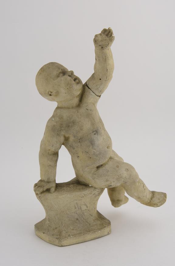 1 Plaster statuette, boy nude in sitting posture