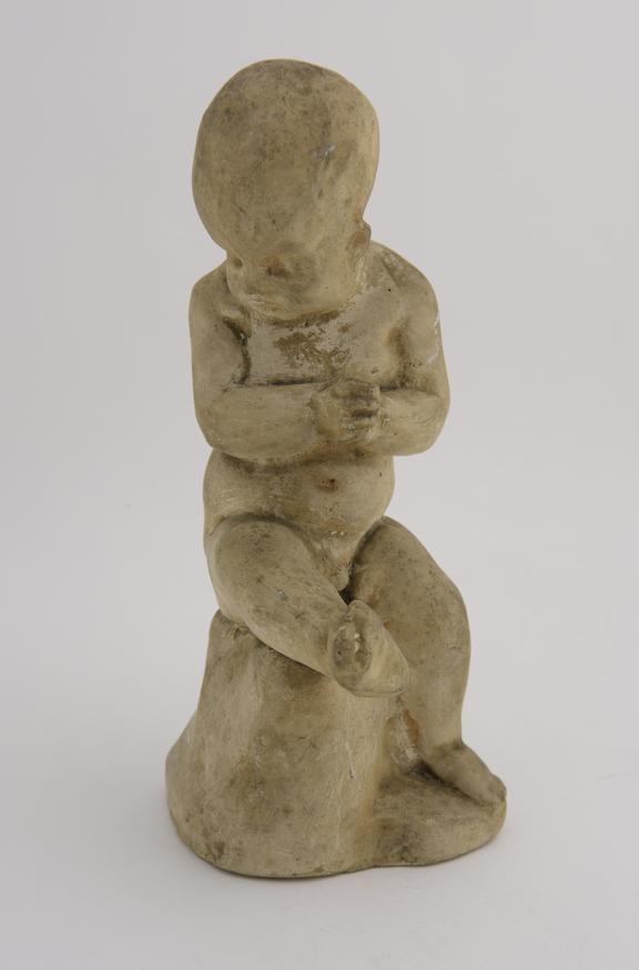 1 Plaster statuette, boy nude in sitting posture, hands clasped