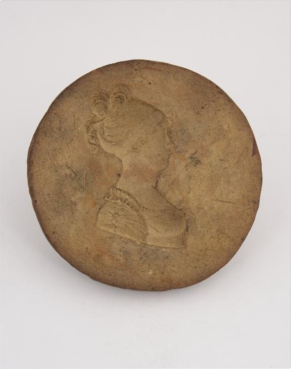 1 Plaster mould, woman with band round her hair, facing left