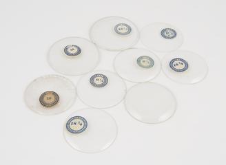 Nine assorted watch glasses.