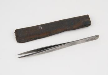Pair of tweezers in a case.