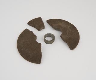 Four fragments, of emery composition lathe operated grinding wheel