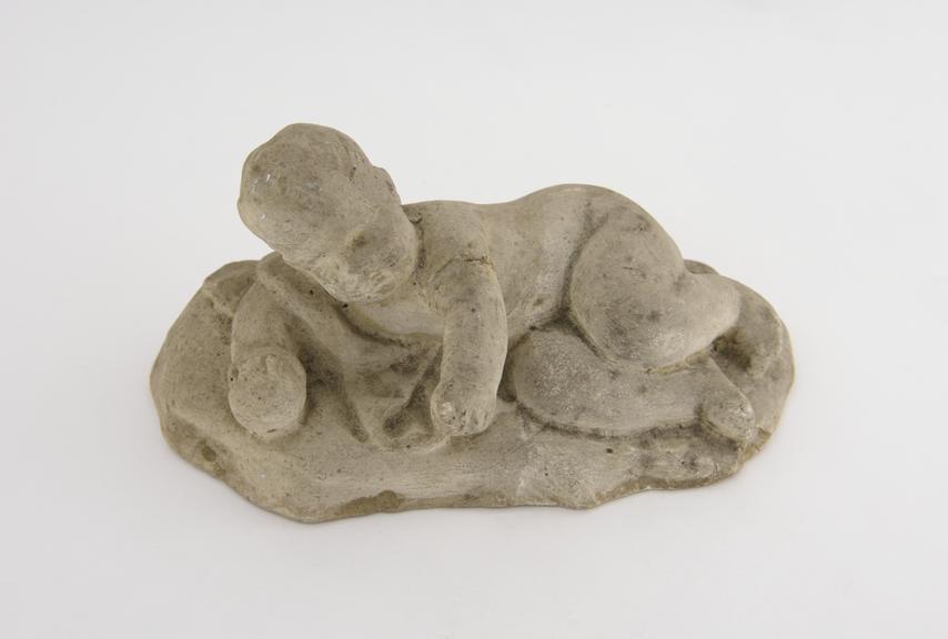 1 Plaster statuette, boy nude lying on his side