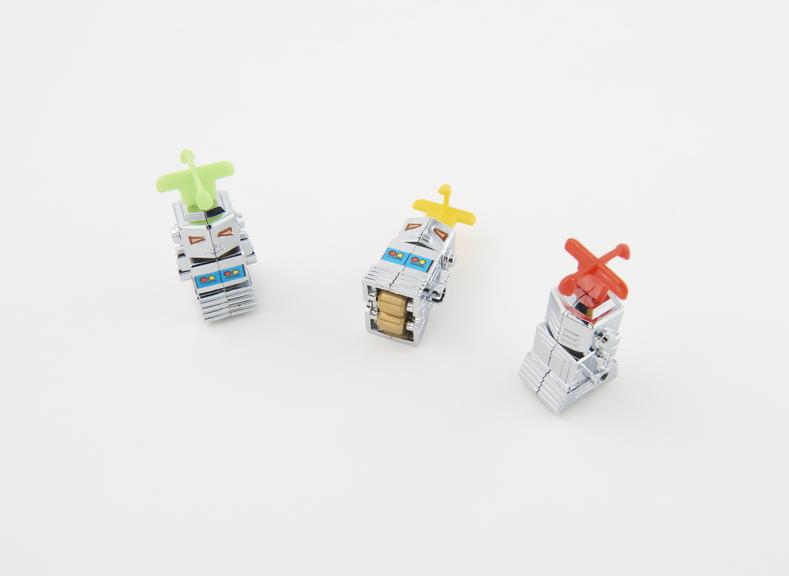 Three silver mini-robots for Kinsman Robot Machine