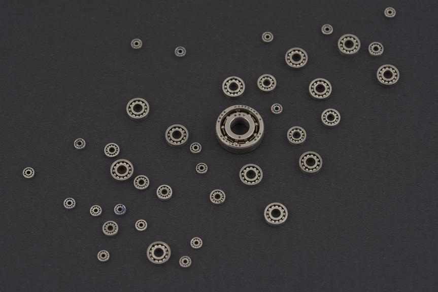 Examples of five sizes of miniature ball-bearings on a display