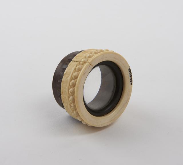 Prismatic lens in ivory and lignum vitae