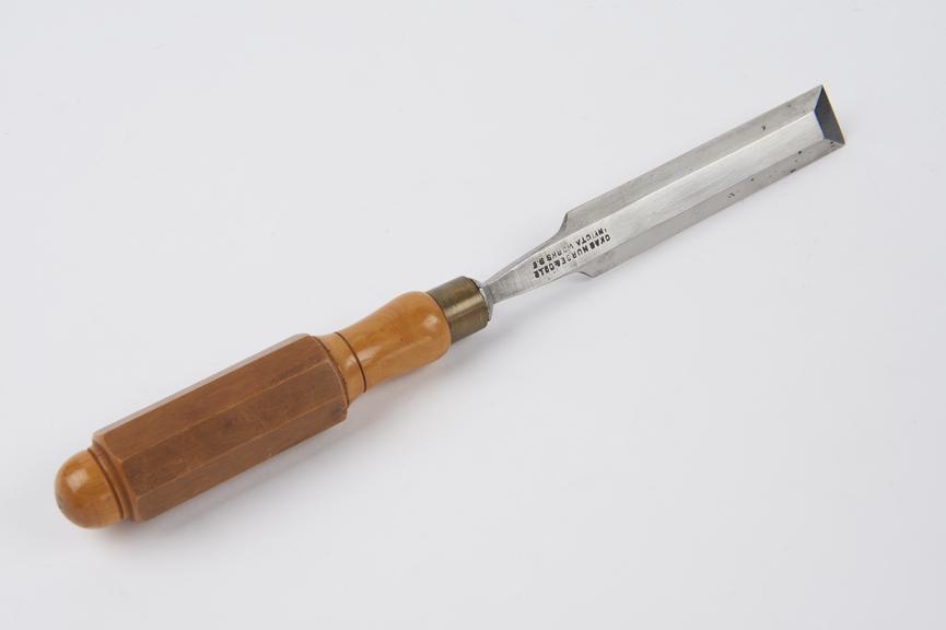 A 1 1/4 bevel edged firmer chisel with a London octagonal box