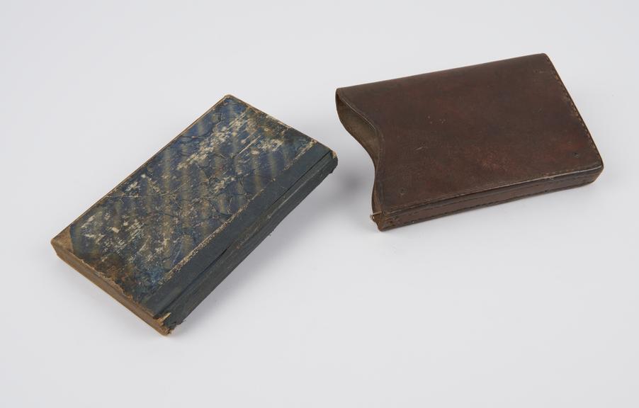 Saddle maker's note book in a hide leather holder.
