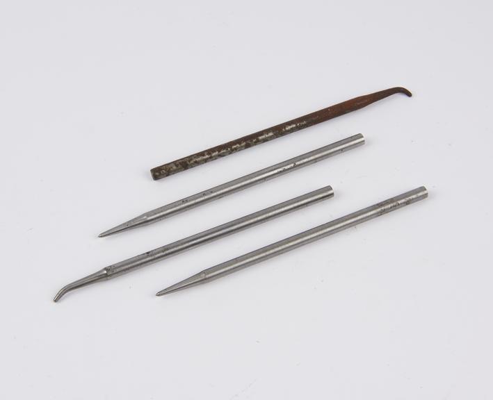 Two straight pointed instruments, plus two curved tip pointed instruments (instruments)