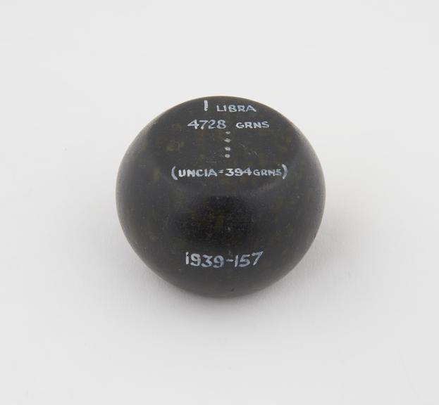 One of 15 Roman weights, cheese-shaped, polished black basalt