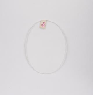 Oval white double convex pebble spectacle lens with a grooved edge