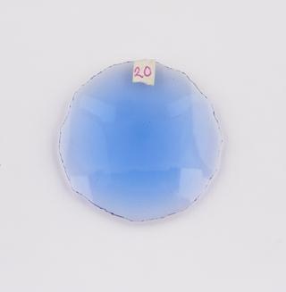 Round blue double convex cataract lens.