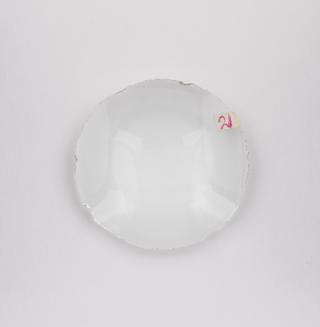 Round white double convex cataract lens.