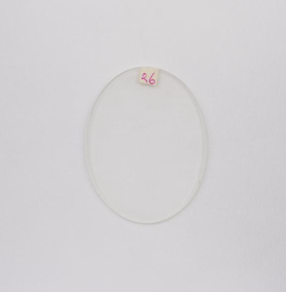 Oval white convex spectacle lens with bevelled edge for frame